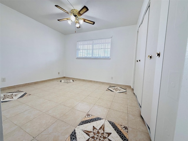 6405 Westward St Unit 96, Houston, TX 77081 - unfurnished bedroom featuring light tile patterned flooring, a closet, a ceiling fan, and baseboards