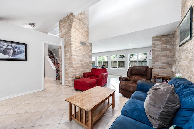 22331 Unicorns Horn Ln, Katy, TX 77449 - living area with stairway, light tile patterned floors, decorative columns, vaulted ceiling, and baseboards