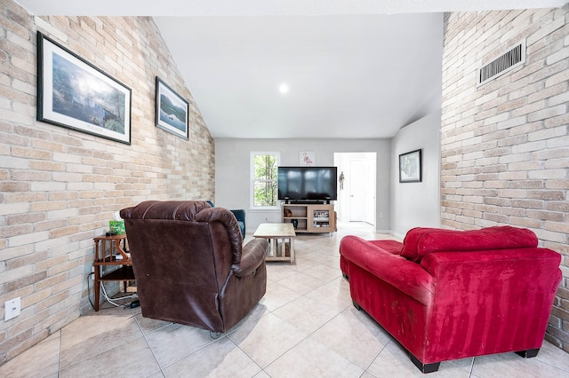22331 Unicorns Horn Ln, Katy, TX 77449 - living room with brick wall, vaulted ceiling, and light tile patterned flooring