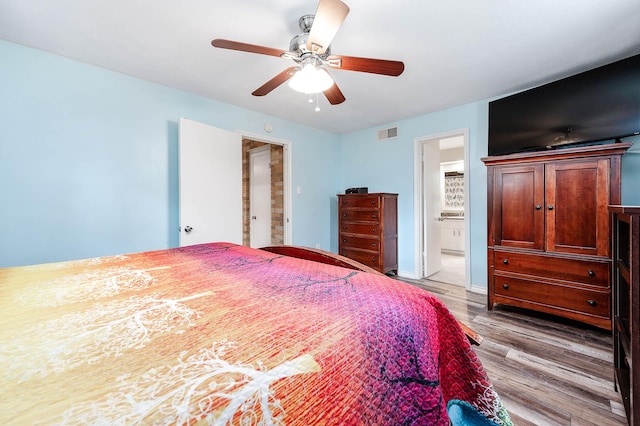 22331 Unicorns Horn Ln, Katy, TX 77449 - bedroom featuring wood finished floors, ensuite bathroom, ceiling fan, and baseboards