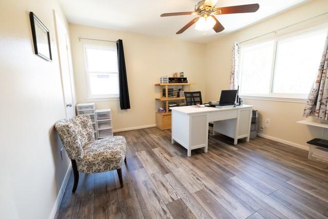 22331 Unicorns Horn Ln, Katy, TX 77449 - office area with a ceiling fan, wood finished floors, and baseboards
