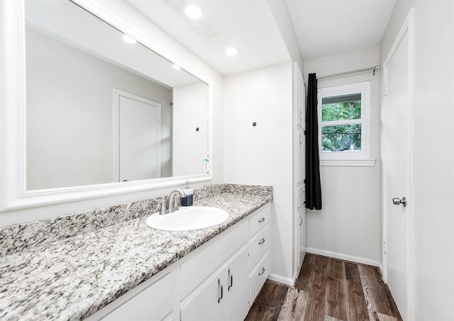 22331 Unicorns Horn Ln, Katy, TX 77449 - bathroom with wood finished floors, recessed lighting, vanity, and baseboards