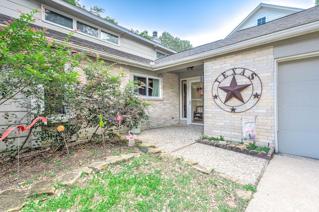 22331 Unicorns Horn Ln, Katy, TX 77449 - property entrance featuring brick siding, an attached garage, and roof with shingles