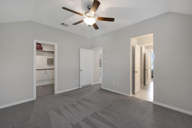 16114 Lake Amistad Pl, Cypress, TX 77433 - unfurnished bedroom featuring lofted ceiling, a spacious closet, carpet floors, ceiling fan, and baseboards