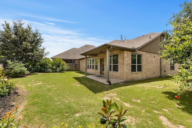 16114 Lake Amistad Pl, Cypress, TX 77433 - rear view of property featuring a lawn, a patio, brick siding, and a shingled roof