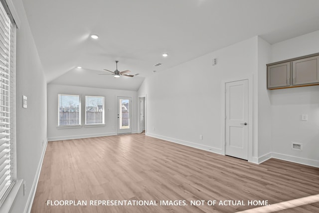 975 Oak Mist Ln, Magnolia, TX 77354 - unfurnished living room with ceiling fan, light wood-style flooring, baseboards, lofted ceiling, and recessed lighting