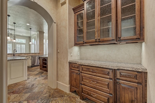 61 Parkgate, Shenandoah, TX 77381 - bar area with dishwasher, stone tile flooring, arched walkways, a sink, and hanging light fixtures