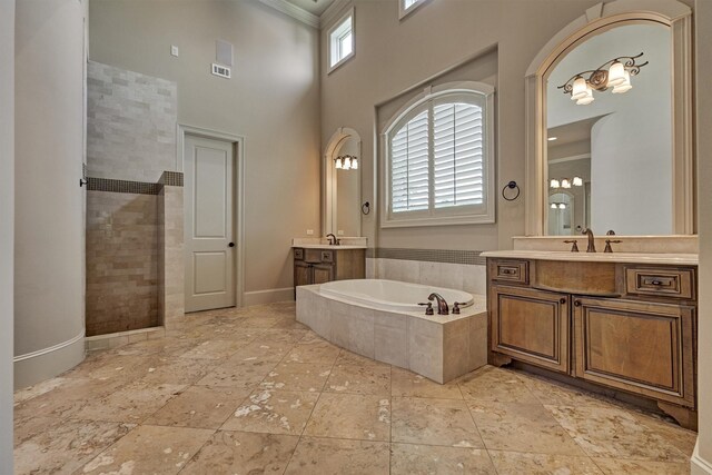 61 Parkgate, Shenandoah, TX 77381 - full bath with plenty of natural light, a garden tub, two vanities, crown molding, and a high ceiling