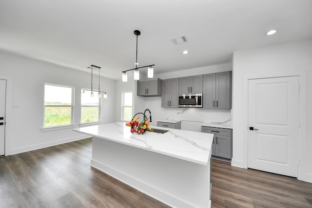 6273 Rd 5503, Cleveland, TX 77327 - kitchen featuring stainless steel microwave, gray cabinets, light stone countertops, a sink, and dark wood finished floors