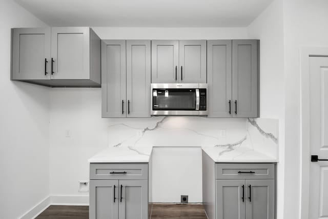 6273 Rd 5503, Cleveland, TX 77327 - kitchen featuring gray cabinets, stainless steel microwave, tasteful backsplash, and light stone counters