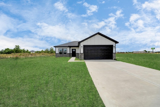 6273 Rd 5503, Cleveland, TX 77327 - view of front of home featuring a front lawn, a garage, concrete driveway, and stone siding
