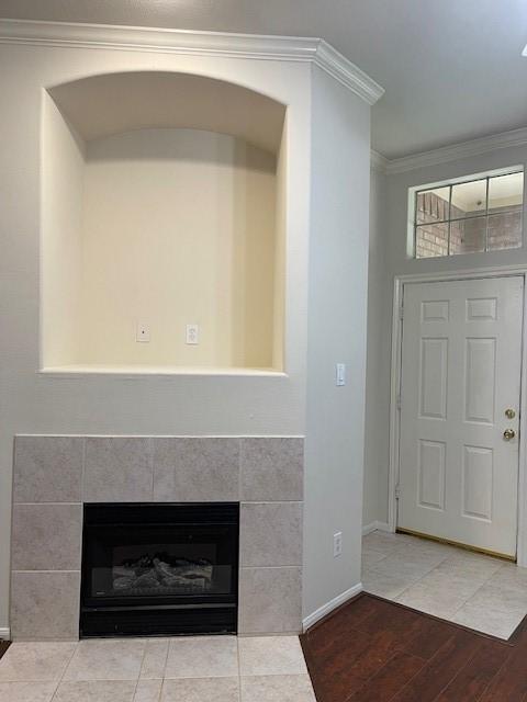 2710 Grants Lake Blvd Unit S4, Sugar Land, TX 77479 - detailed view of ornamental molding, wood finished floors, baseboards, a tiled fireplace, and arched walkways