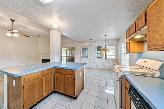 7110 Pine Bower Ct, Humble, TX 77346 - kitchen with white electric stove, wallpapered walls, a fireplace, under cabinet range hood, and a ceiling fan