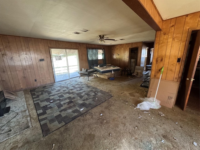 24532 Tyrone, Hempstead, TX 77445 - unfurnished living room with wood walls and a ceiling fan