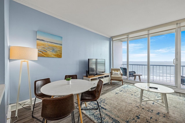 1401 E Beach Dr Unit 1205, Galveston, TX 77550 - dining area featuring floor to ceiling windows, wood finished floors, and crown molding