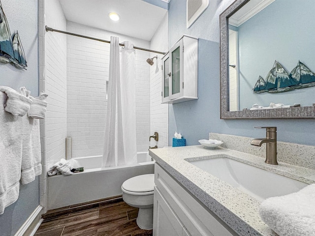 1401 E Beach Dr Unit 1205, Galveston, TX 77550 - bathroom featuring wood finished floors, toilet, shower / tub combo, and vanity