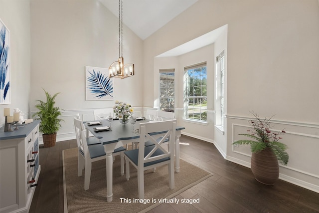 dining room with vaulted ceiling, dark wood-type flooring, a chandelier, and a wainscoted wall