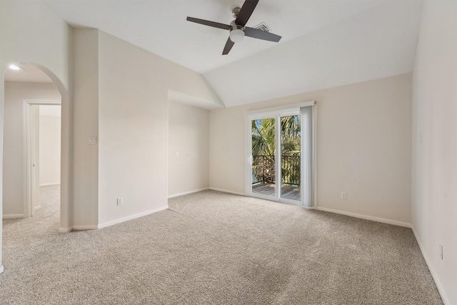 carpeted spare room featuring ceiling fan, arched walkways, lofted ceiling, and baseboards