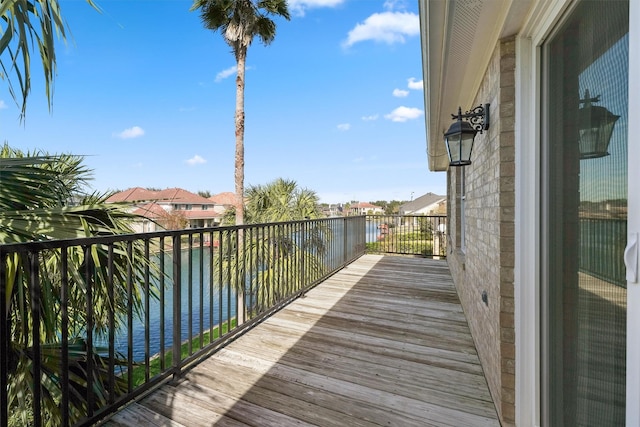 balcony featuring a water view and a residential view