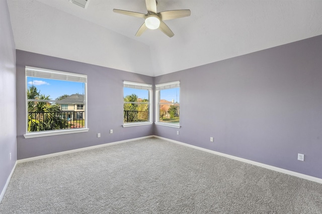 empty room with carpet floors, lofted ceiling, and baseboards