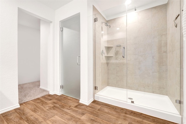 21614 Gusto Glen Ln, Katy, TX 77449 - bathroom with wood finished floors, a stall shower, and baseboards