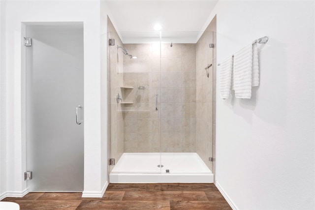 21614 Gusto Glen Ln, Katy, TX 77449 - full bathroom featuring a stall shower, wood finished floors, and baseboards