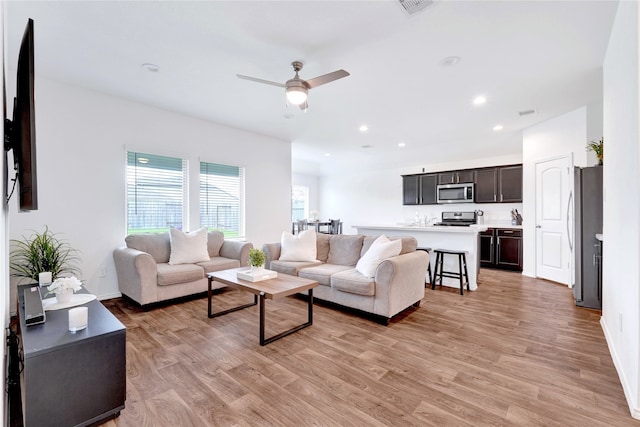 21614 Gusto Glen Ln, Katy, TX 77449 - living area with light wood-style floors, a ceiling fan, recessed lighting, and baseboards