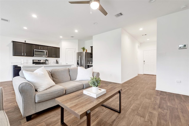 21614 Gusto Glen Ln, Katy, TX 77449 - living area with a ceiling fan, light wood-style floors, recessed lighting, and baseboards