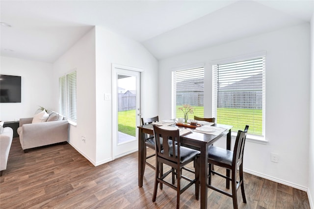 21614 Gusto Glen Ln, Katy, TX 77449 - dining space featuring dark wood-type flooring, baseboards, and lofted ceiling