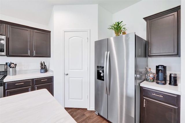 21614 Gusto Glen Ln, Katy, TX 77449 - kitchen with stainless steel appliances, dark brown cabinets, light countertops, and wood finished floors