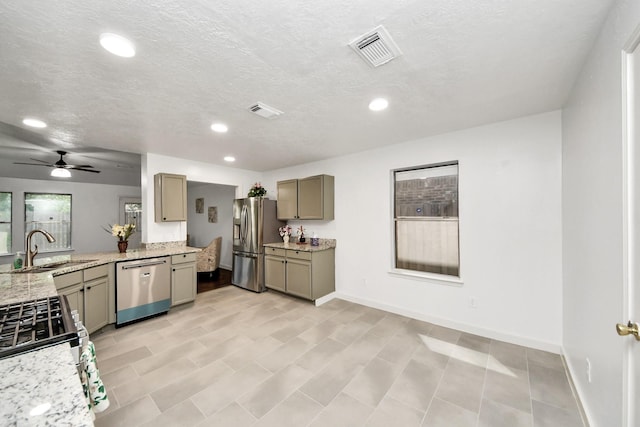 9223 Eaglewood Glen Trl, Houston, TX 77083 - kitchen with appliances with stainless steel finishes, a sink, gray cabinetry, recessed lighting, and light stone counters