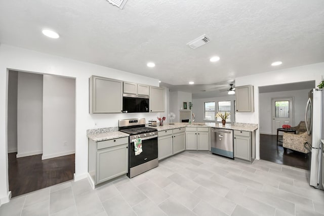 9223 Eaglewood Glen Trl, Houston, TX 77083 - kitchen with stainless steel appliances, gray cabinets, a ceiling fan, recessed lighting, and light stone counters