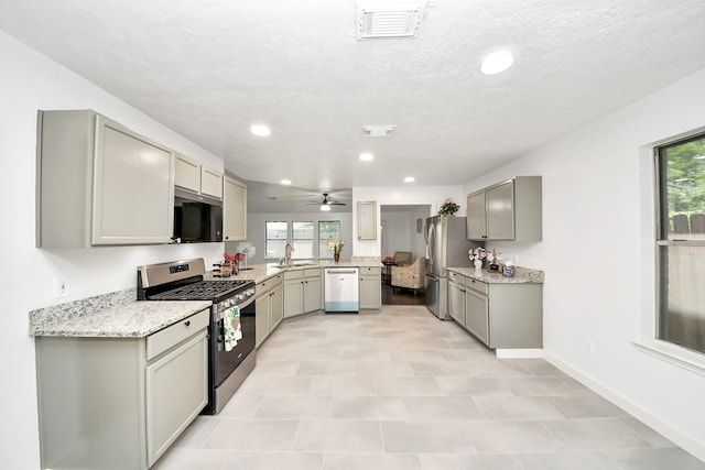 9223 Eaglewood Glen Trl, Houston, TX 77083 - kitchen featuring stainless steel appliances, gray cabinetry, a sink, plenty of natural light, and recessed lighting