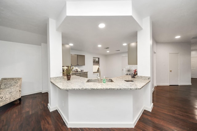 9223 Eaglewood Glen Trl, Houston, TX 77083 - kitchen with a sink, gray cabinets, wood finished floors, light stone countertops, and recessed lighting