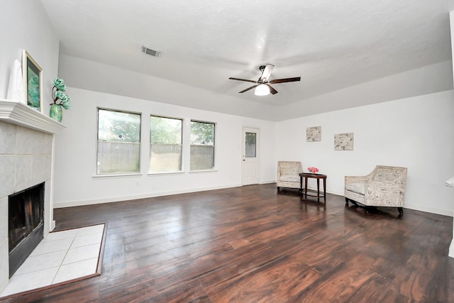 9223 Eaglewood Glen Trl, Houston, TX 77083 - sitting room featuring ceiling fan, a tiled fireplace, wood finished floors, and baseboards