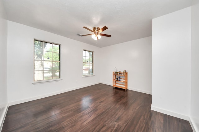 9223 Eaglewood Glen Trl, Houston, TX 77083 - spare room with dark wood-style floors, a ceiling fan, and baseboards