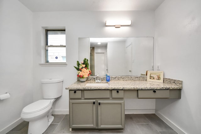 9223 Eaglewood Glen Trl, Houston, TX 77083 - bathroom featuring baseboards, toilet, and vanity