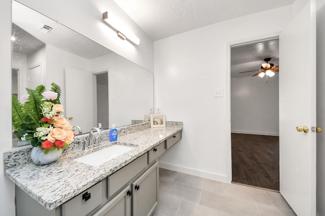 9223 Eaglewood Glen Trl, Houston, TX 77083 - bathroom with tile patterned floors, a ceiling fan, baseboards, and vanity