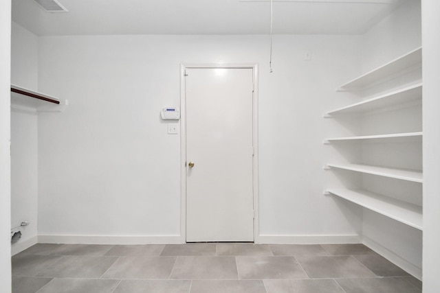 9223 Eaglewood Glen Trl, Houston, TX 77083 - clothes washing area featuring tile patterned floors and baseboards