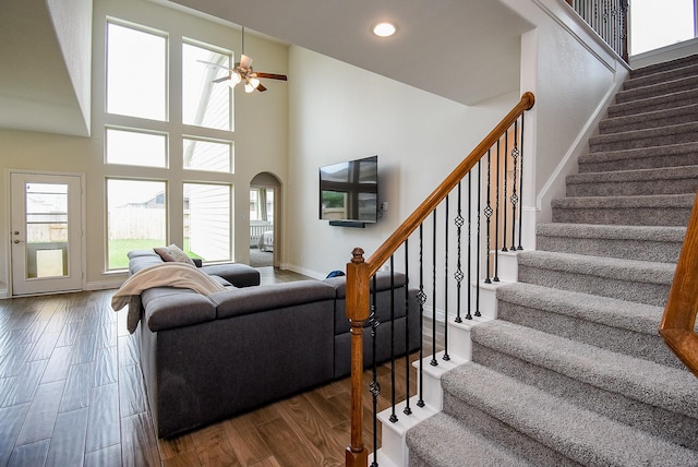 2804 Sable Creek Ln, Pearland, TX 77584 - living area with stairway, a ceiling fan, wood finished floors, baseboards, and a high ceiling
