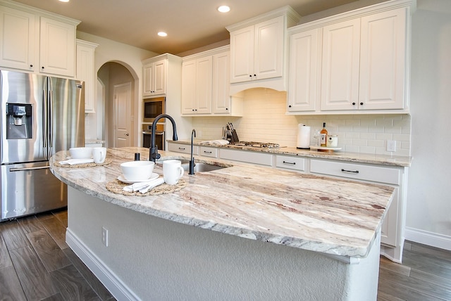 2804 Sable Creek Ln, Pearland, TX 77584 - kitchen with appliances with stainless steel finishes, arched walkways, recessed lighting, baseboards, and white cabinetry