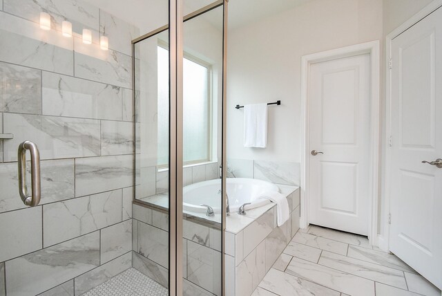 2804 Sable Creek Ln, Pearland, TX 77584 - full bathroom featuring marble look tile flooring, a shower stall, and a garden tub