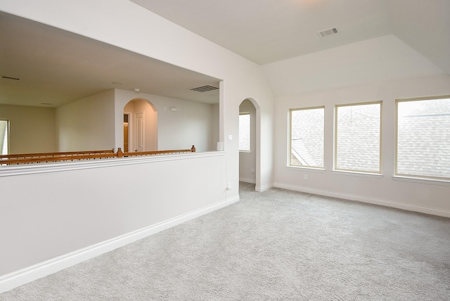 2804 Sable Creek Ln, Pearland, TX 77584 - empty room with arched walkways, light carpet, baseboards, and vaulted ceiling