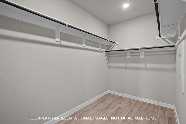 528 Flower Reed Ct, Magnolia, TX 77354 - walk in closet with wood finished floors