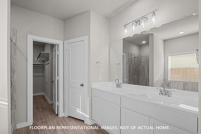 528 Flower Reed Ct, Magnolia, TX 77354 - full bath featuring a shower stall, wood finished floors, a spacious closet, and double vanity