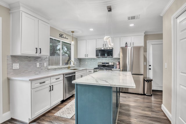 1118 Cheyenne Meadows Dr, Katy, TX 77450 - kitchen featuring stainless steel appliances, dark wood-style floors, ornamental molding, white cabinetry, and tasteful backsplash