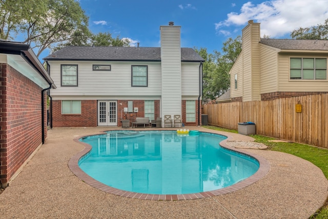 1118 Cheyenne Meadows Dr, Katy, TX 77450 - view of pool featuring french doors, a patio, a fenced backyard, and central air condition unit
