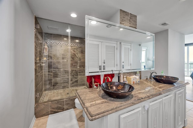 1401 E Beach Dr Unit 805/06, Galveston, TX 77550 - full bath with recessed lighting, a shower stall, tile patterned floors, double vanity, and toilet
