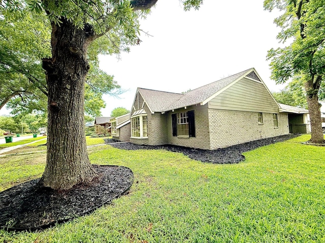 5602 Valkeith Dr, Houston, TX 77096 - view of side of home featuring brick siding, a yard, and a shingled roof