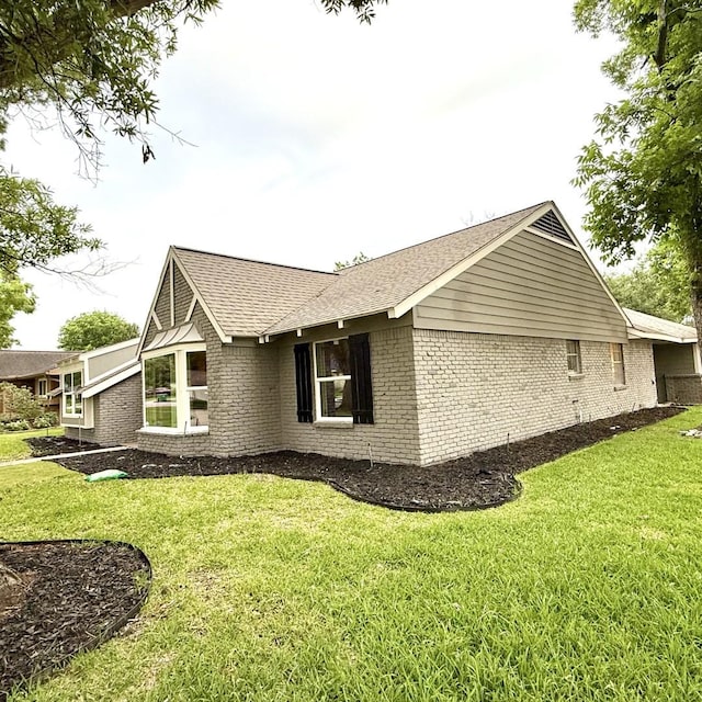 5602 Valkeith Dr, Houston, TX 77096 - view of side of home with brick siding, a yard, and a shingled roof